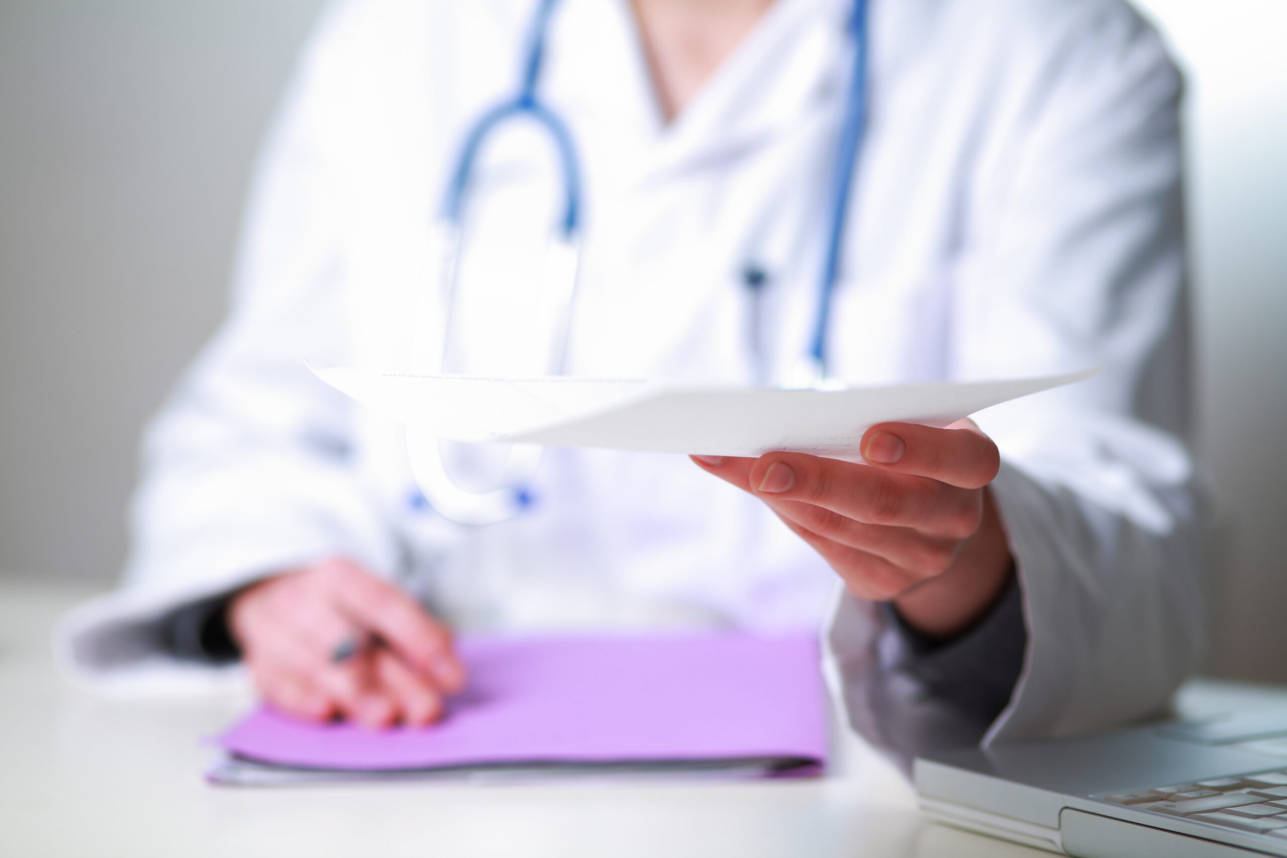 female doctor giving a prescription to focus on the hand